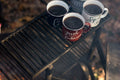 four assorted-color ceramic mugs on black grill frame - Credit to https://myfriendscoffee.com/